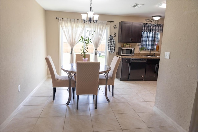 16863 SW 29th Terrace Rd, Ocala, FL 34473 - dining space with a textured wall, a chandelier, and light tile patterned floors
