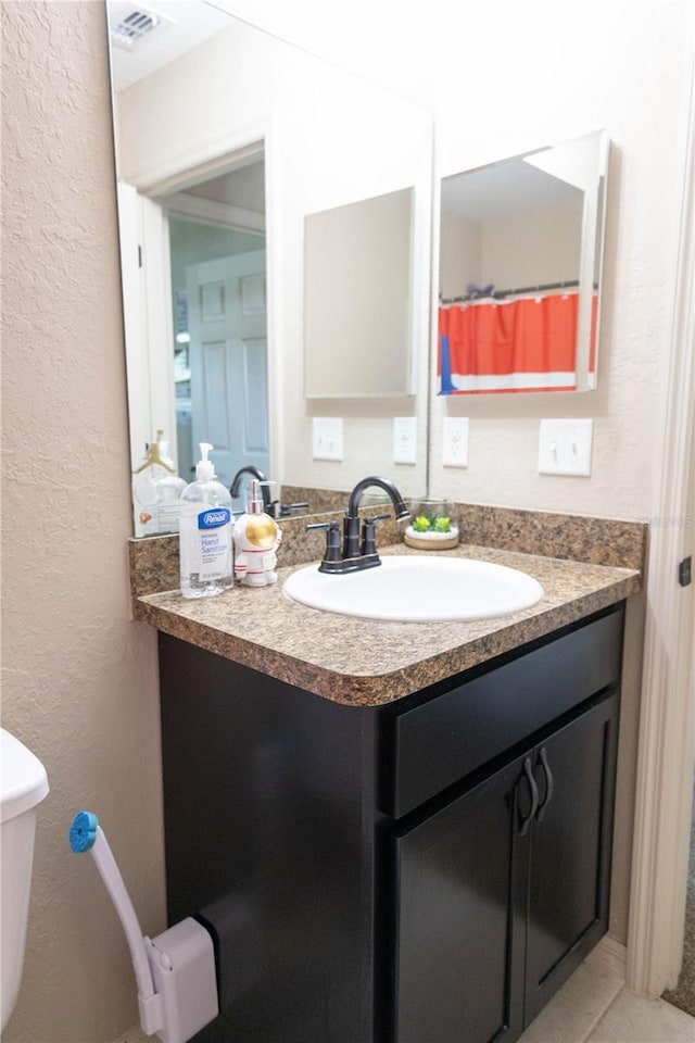 16863 SW 29th Terrace Rd, Ocala, FL 34473 - bathroom featuring a textured wall, vanity, and tile patterned flooring