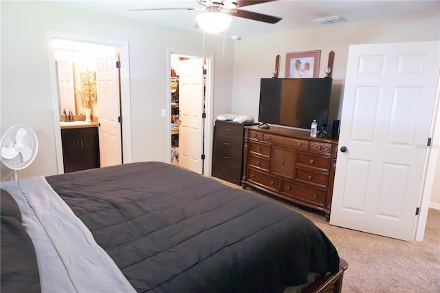 16863 SW 29th Terrace Rd, Ocala, FL 34473 - bedroom with light carpet, a spacious closet, ceiling fan, a closet, and connected bathroom