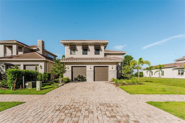 15942 Vetta Dr, Bella Collina, FL 34756 - mediterranean / spanish home featuring a garage, a tile roof, decorative driveway, stucco siding, and a front yard