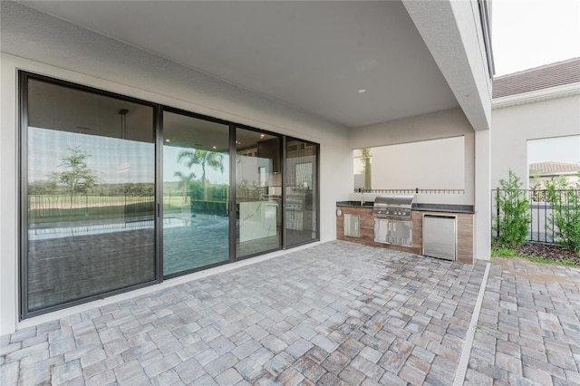 15942 Vetta Dr, Bella Collina, FL 34756 - view of patio / terrace with exterior kitchen and a sink