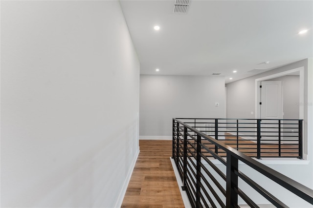 15942 Vetta Dr, Bella Collina, FL 34756 - hall featuring an upstairs landing, recessed lighting, and wood finished floors