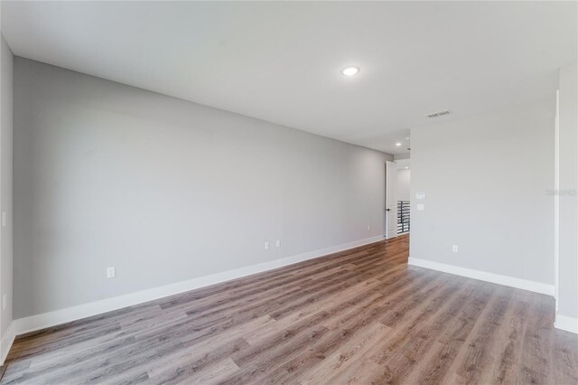 15942 Vetta Dr, Bella Collina, FL 34756 - unfurnished room featuring wood finished floors and recessed lighting