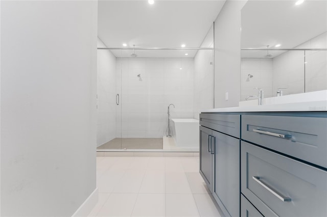15942 Vetta Dr, Bella Collina, FL 34756 - bathroom featuring a shower stall, recessed lighting, vanity, a freestanding bath, and tile patterned flooring