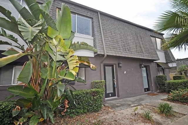 1922 Conway Rd Unit 1922, Orlando, FL 32812 - back of house featuring mansard roof and stucco siding