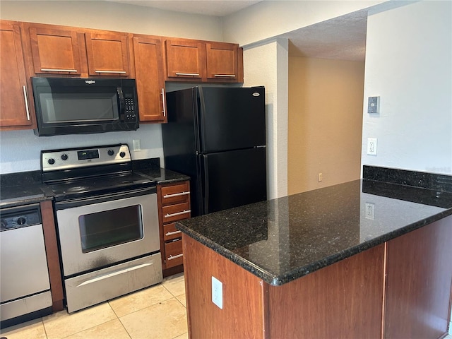 1922 Conway Rd Unit 1922, Orlando, FL 32812 - kitchen with black appliances, brown cabinets, light tile patterned flooring, dark stone countertops, and a peninsula