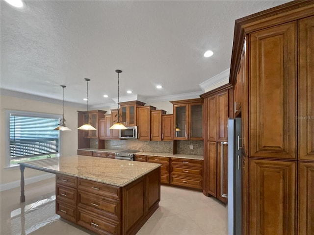 11356 Callaway Pond Dr, Riverview, FL 33579 - kitchen featuring stainless steel appliances, brown cabinetry, backsplash, a kitchen island, and light stone countertops