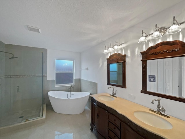 11356 Callaway Pond Dr, Riverview, FL 33579 - full bath with a shower stall, a freestanding bath, double vanity, a textured ceiling, and tile patterned flooring
