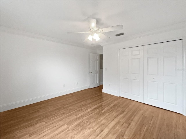 11356 Callaway Pond Dr, Riverview, FL 33579 - unfurnished bedroom with ornamental molding, light wood-style flooring, a closet, and a ceiling fan