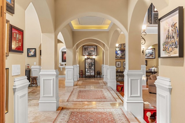 9400 Laws Rd, Clermont, FL 34714 - corridor featuring arched walkways, inlaid floor details, crown molding, and a decorative wall