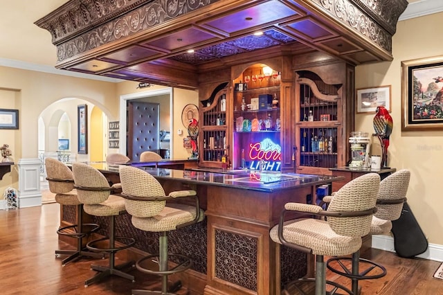 9400 Laws Rd, Clermont, FL 34714 - indoor dry bar with arched walkways, wood finished floors, and ornamental molding