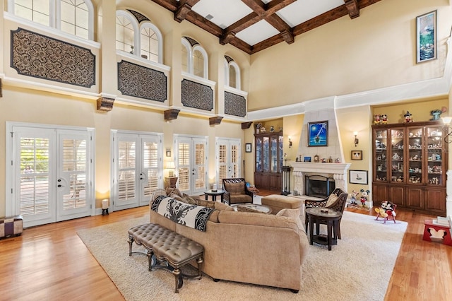 9400 Laws Rd, Clermont, FL 34714 - living area featuring a towering ceiling, french doors, coffered ceiling, wood finished floors, and beam ceiling