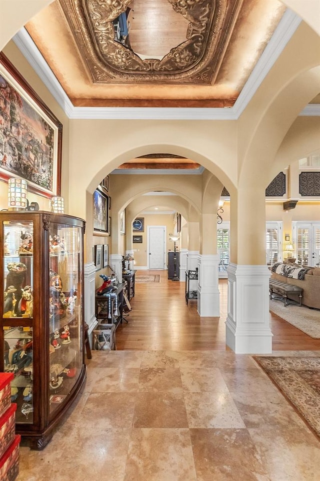 9400 Laws Rd, Clermont, FL 34714 - foyer entrance featuring arched walkways, crown molding, a tray ceiling, and ornate columns