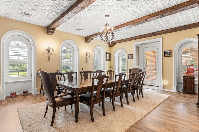 9400 Laws Rd, Clermont, FL 34714 - dining space with an ornate ceiling, beam ceiling, light wood-type flooring, a chandelier, and arched walkways