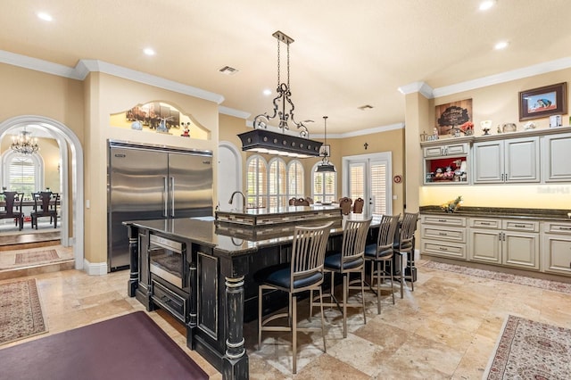 9400 Laws Rd, Clermont, FL 34714 - kitchen featuring stainless steel appliances, a large island, crown molding, a breakfast bar area, and recessed lighting