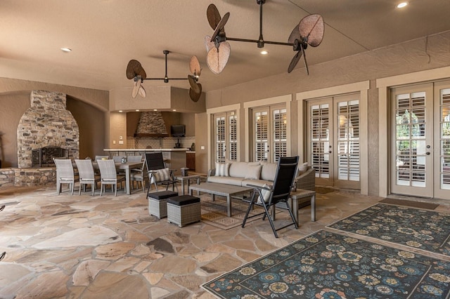 9400 Laws Rd, Clermont, FL 34714 - view of patio / terrace featuring french doors, a fireplace, and outdoor dining space