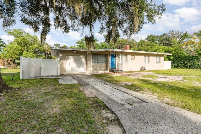 131 N Central Ave, Apopka, FL 32703 - ranch-style house with concrete driveway, a chimney, and a garage
