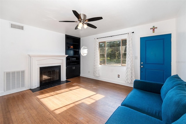 131 N Central Ave, Apopka, FL 32703 - living area featuring ceiling fan, a fireplace with flush hearth, and wood finished floors