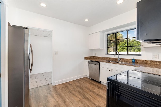 131 N Central Ave, Apopka, FL 32703 - kitchen featuring stainless steel appliances, dark stone countertops, white cabinetry, light wood-type flooring, and recessed lighting