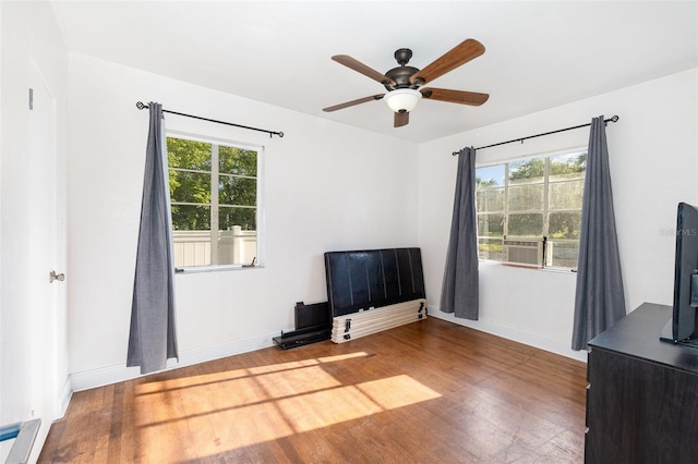 131 N Central Ave, Apopka, FL 32703 - unfurnished bedroom featuring wood finished floors, multiple windows, and a ceiling fan