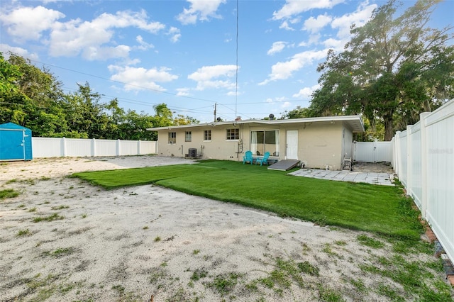 131 N Central Ave, Apopka, FL 32703 - back of property featuring a fenced backyard, a patio, and a shed