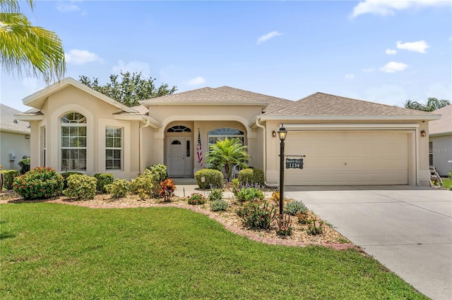1254 Spartanburg Way, The Villages, FL 32162 - view of front of property featuring an attached garage, a front yard, stucco siding, and concrete driveway