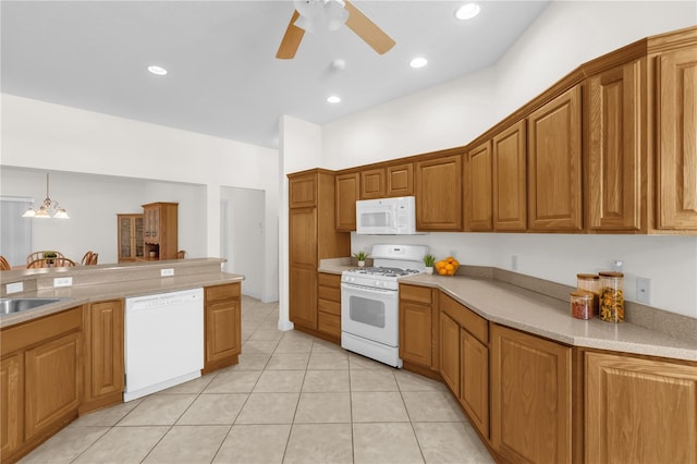 1254 Spartanburg Way, The Villages, FL 32162 - kitchen featuring white appliances, a ceiling fan, brown cabinetry, and light countertops