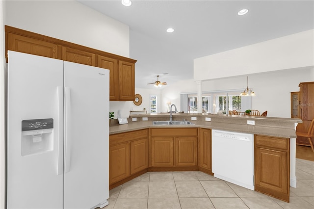 1254 Spartanburg Way, The Villages, FL 32162 - kitchen featuring white appliances, light tile patterned floors, brown cabinets, light countertops, and recessed lighting