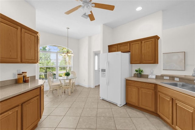 1254 Spartanburg Way, The Villages, FL 32162 - kitchen featuring white refrigerator with ice dispenser, a ceiling fan, brown cabinets, decorative light fixtures, and light tile patterned flooring