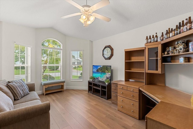 1254 Spartanburg Way, The Villages, FL 32162 - living room with light wood-style floors, a ceiling fan, and vaulted ceiling
