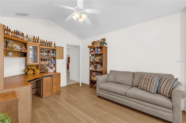 1254 Spartanburg Way, The Villages, FL 32162 - living room with light wood-style flooring, vaulted ceiling, ceiling fan, and a desk