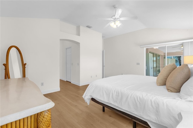 1254 Spartanburg Way, The Villages, FL 32162 - bedroom featuring lofted ceiling, arched walkways, light wood finished floors, access to exterior, and ceiling fan