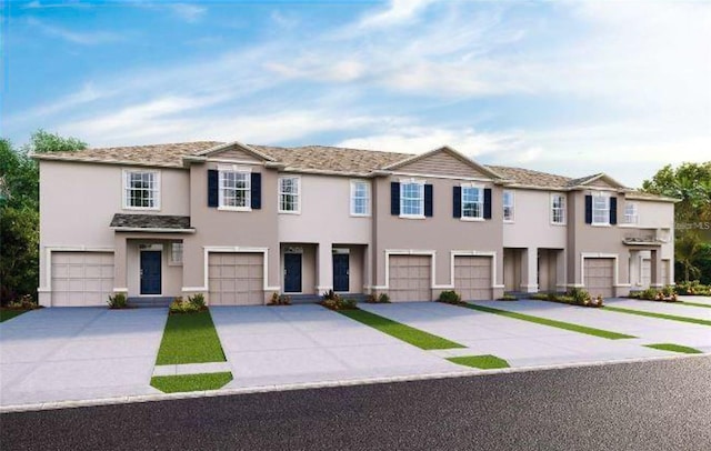 200 Feltrim Reserve Blvd, Davenport, FL 33837 - view of property with stucco siding, concrete driveway, and a garage