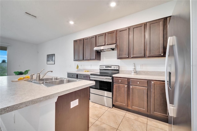 200 Feltrim Reserve Blvd, Davenport, FL 33837 - kitchen featuring stainless steel appliances, under cabinet range hood, light tile patterned flooring, light countertops, and recessed lighting