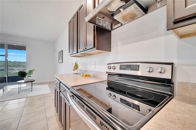 200 Feltrim Reserve Blvd, Davenport, FL 33837 - kitchen with electric range, light countertops, premium range hood, and light tile patterned floors