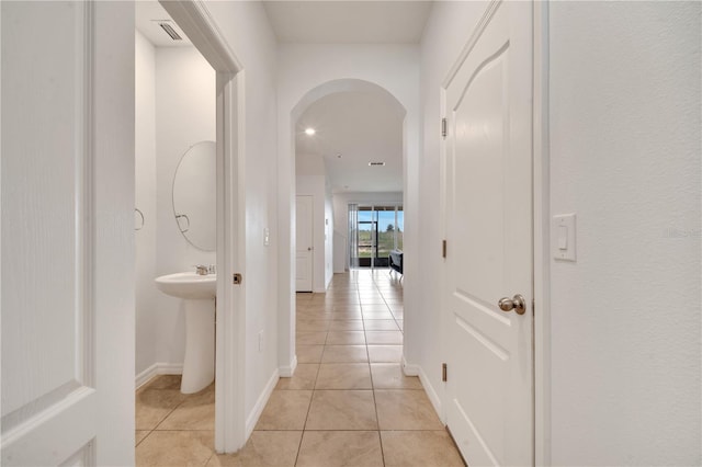 200 Feltrim Reserve Blvd, Davenport, FL 33837 - hallway with arched walkways and light tile patterned floors