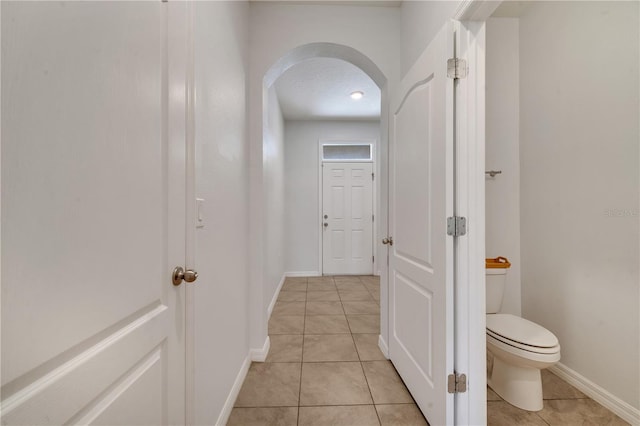 200 Feltrim Reserve Blvd, Davenport, FL 33837 - hallway with arched walkways and light tile patterned flooring