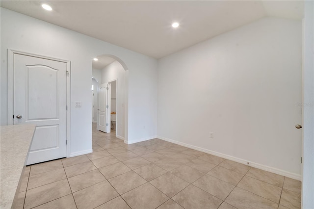 200 Feltrim Reserve Blvd, Davenport, FL 33837 - unfurnished room featuring arched walkways, light tile patterned flooring, recessed lighting, and vaulted ceiling