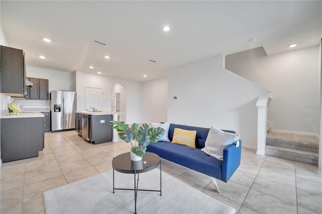 200 Feltrim Reserve Blvd, Davenport, FL 33837 - living room featuring stairway, recessed lighting, light tile patterned floors, and arched walkways