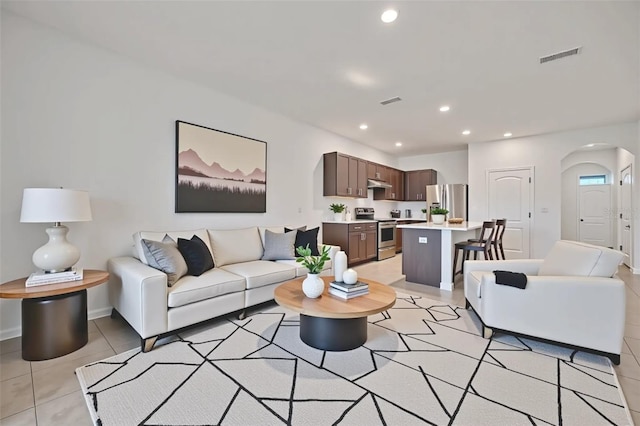 200 Feltrim Reserve Blvd, Davenport, FL 33837 - living room with arched walkways, recessed lighting, and light tile patterned floors