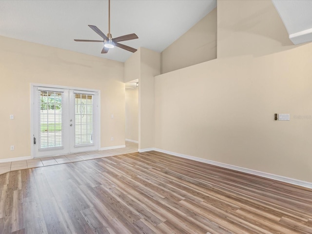 14322 Pine Cone Trl, Clermont, FL 34711 - spare room with light wood-style flooring, high vaulted ceiling, a ceiling fan, and french doors
