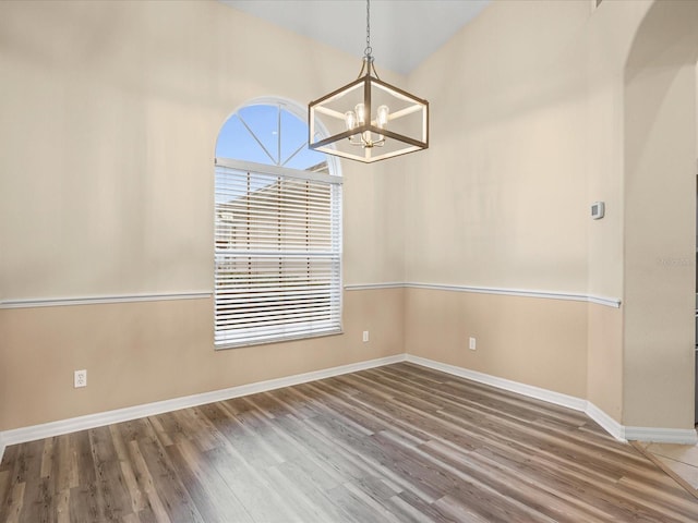 14322 Pine Cone Trl, Clermont, FL 34711 - unfurnished dining area featuring a chandelier and wood finished floors