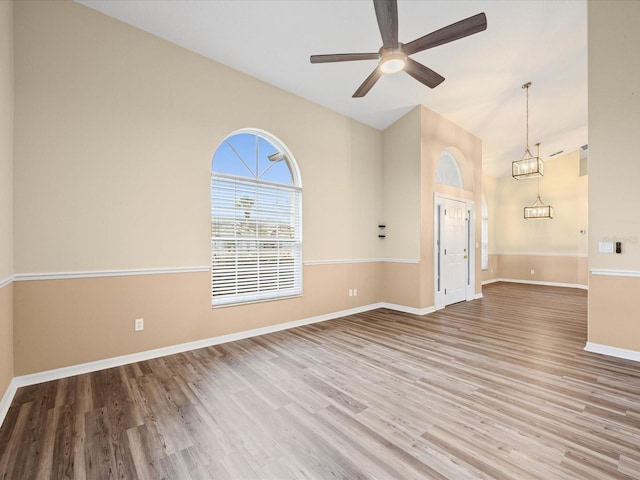 14322 Pine Cone Trl, Clermont, FL 34711 - unfurnished living room with ceiling fan, wood finished floors, and high vaulted ceiling