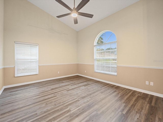 14322 Pine Cone Trl, Clermont, FL 34711 - spare room featuring wood finished floors, a ceiling fan, and high vaulted ceiling