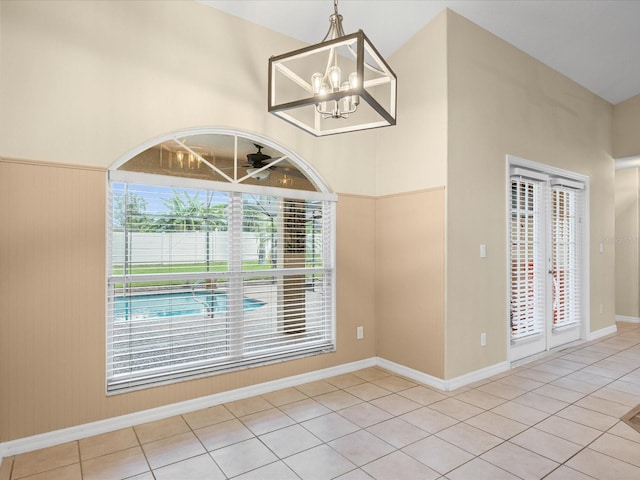 14322 Pine Cone Trl, Clermont, FL 34711 - unfurnished dining area featuring a chandelier, tile patterned floors, and a ceiling fan