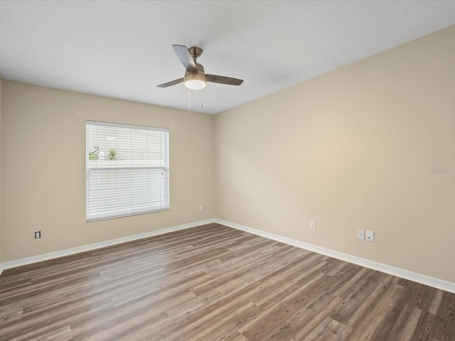 14322 Pine Cone Trl, Clermont, FL 34711 - unfurnished room with wood finished floors and a ceiling fan
