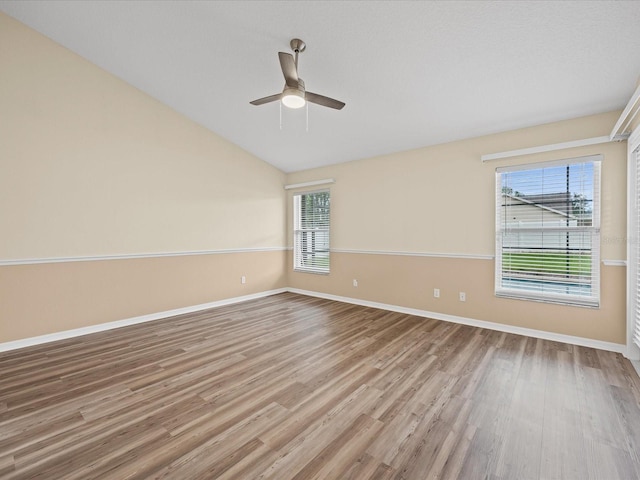 14322 Pine Cone Trl, Clermont, FL 34711 - unfurnished room featuring wood finished floors, a ceiling fan, plenty of natural light, and lofted ceiling