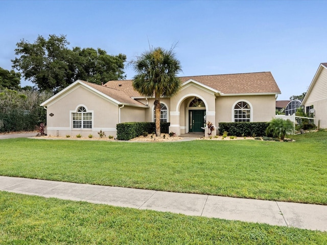 14322 Pine Cone Trl, Clermont, FL 34711 - view of front of house with a front yard and stucco siding