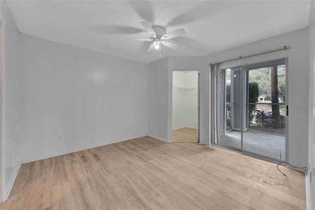 711 Sugar Bay Way Unit 109, Lake Mary, FL 32746 - spare room featuring wood finished floors, ceiling fan, and a textured ceiling