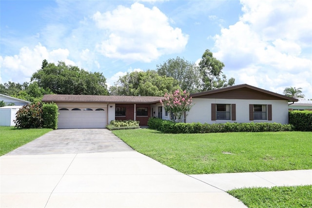 2417 Bayfront Pkwy, Orlando, FL 32806 - ranch-style home with a garage, driveway, and a front lawn